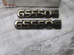 Suzuki GS550E PAIR SIDEPANEL BADGES NOS rare golds colour 68131-47300